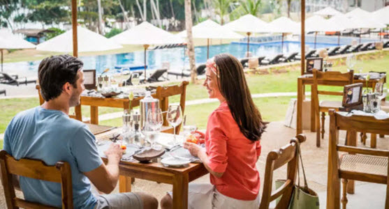 Image of a couple having lunch in holiday resort 
